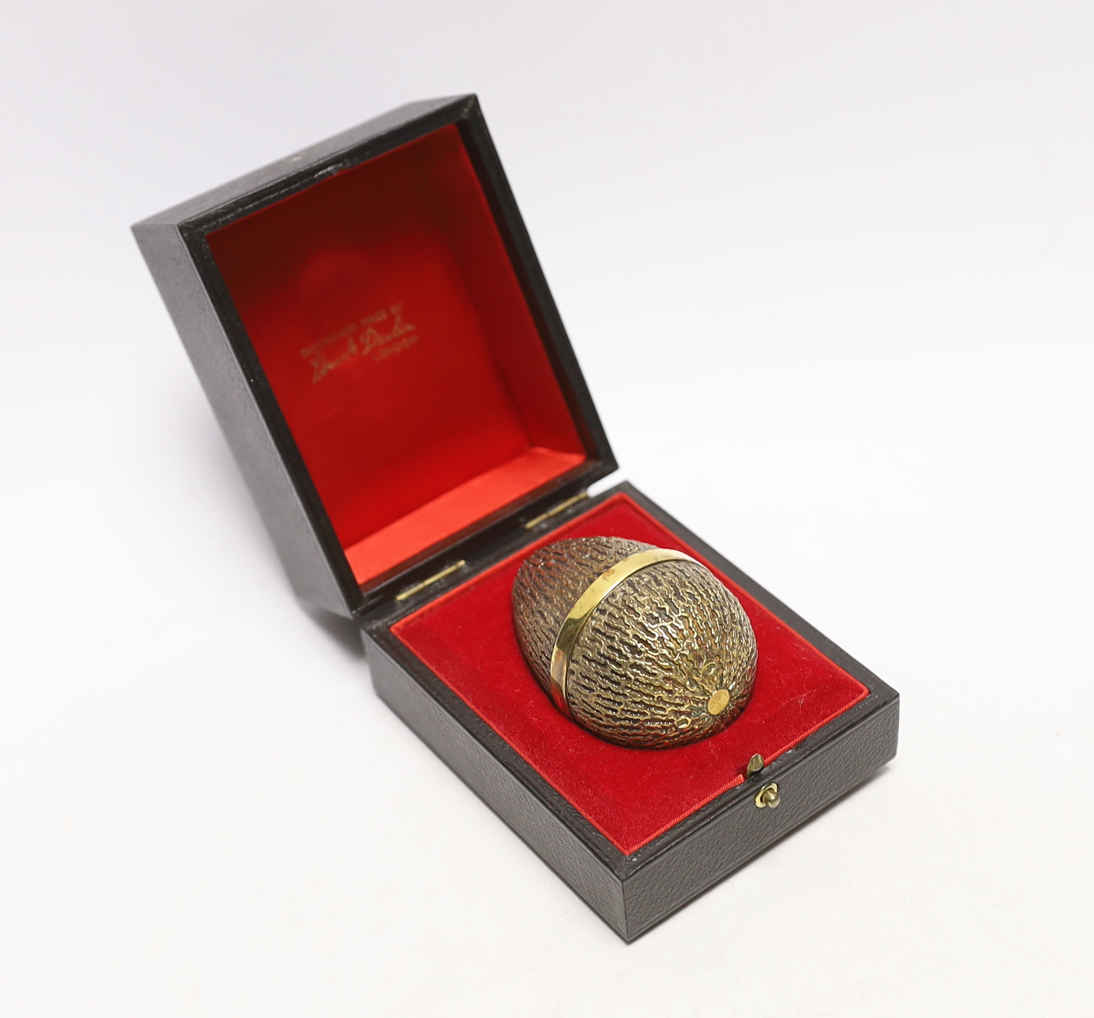 An Elizabeth II silver gilt surprise egg, by Stuart Devlin, London, 1973, numbered 223, opening to reveal an open mouthed hippopotamus, 72mm, in original Devlin box.